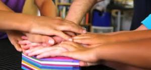 The kids from Sesame Street making a paper sculpture in the video.