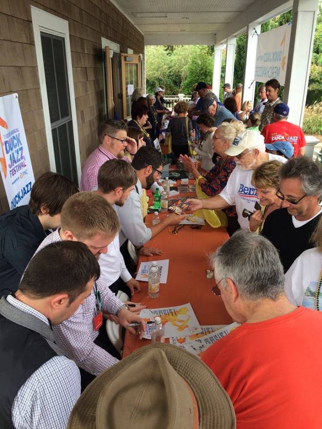 Signing autographs at the merch table after our performance.